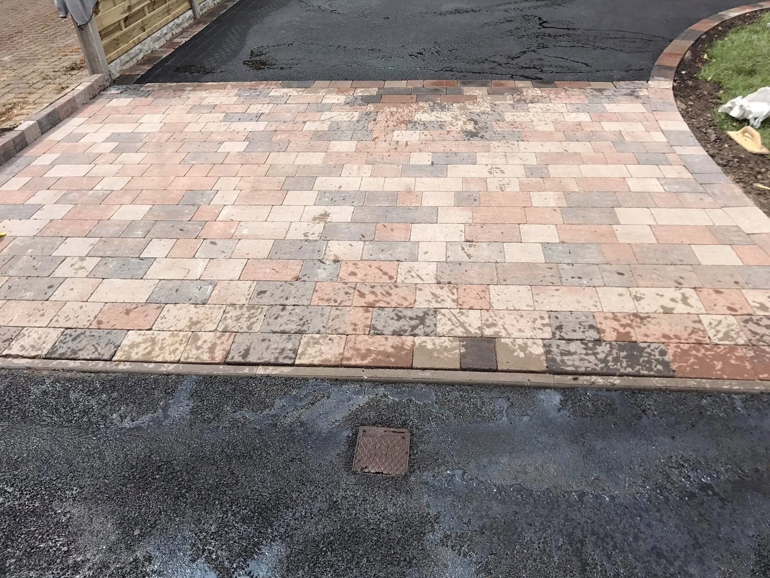 Brindle and buff block paving apron meeting tarmac