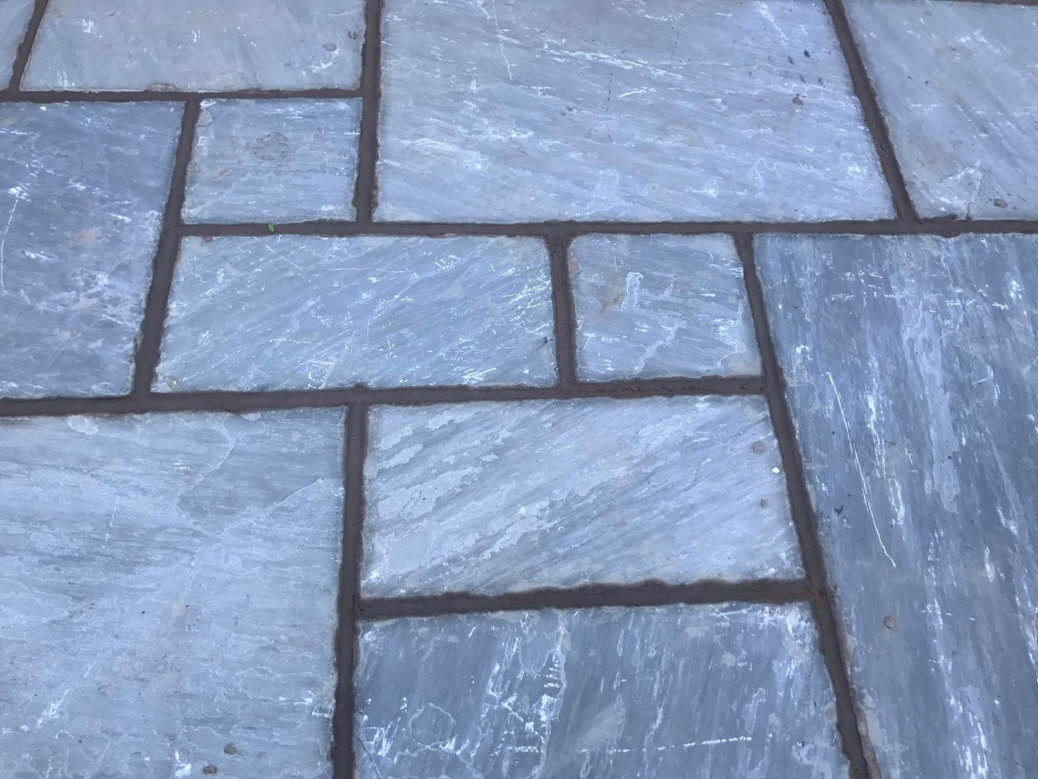 Grey slate paving slabs close up