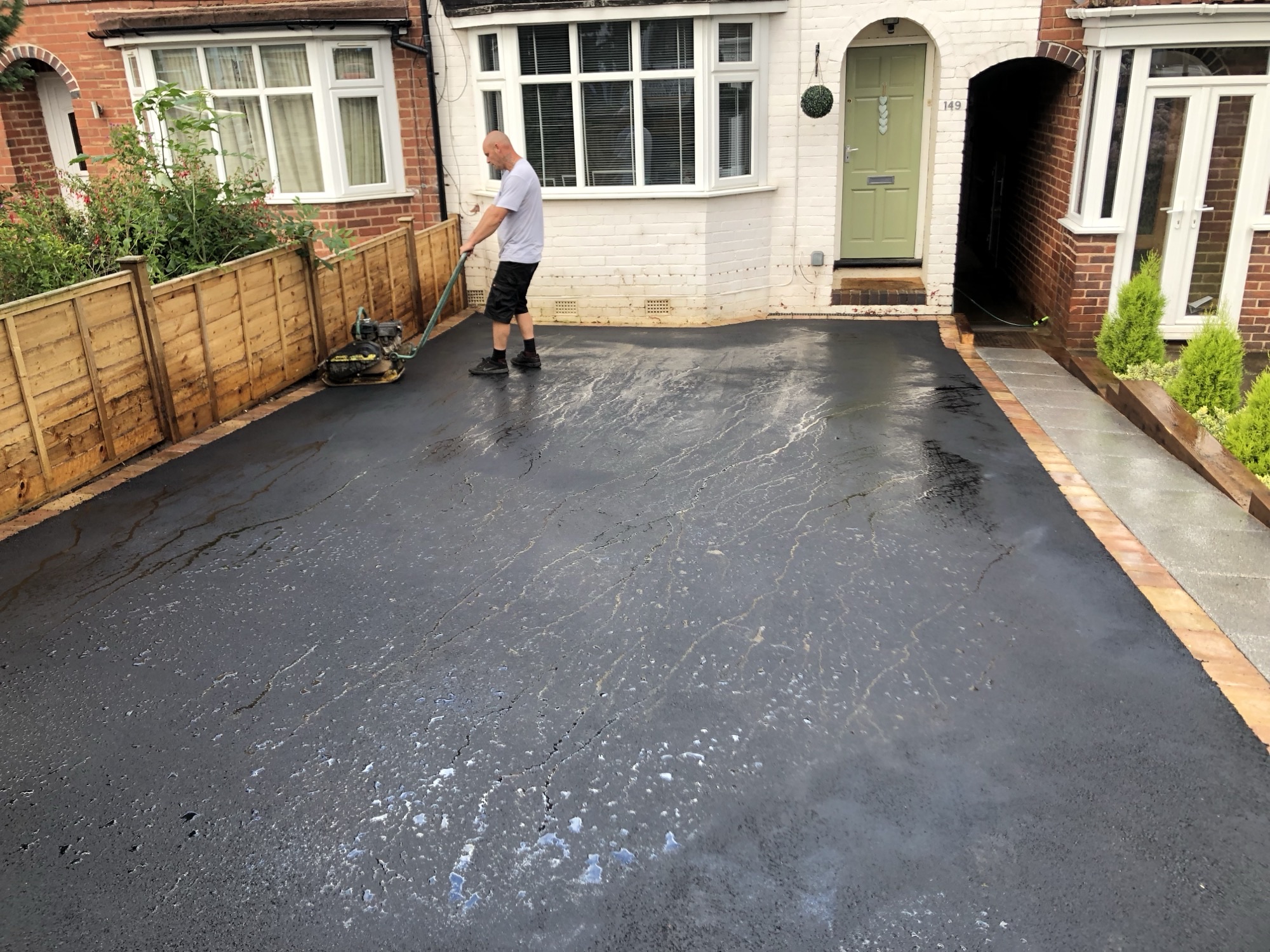 Tarmac driveway being compacted by our crew